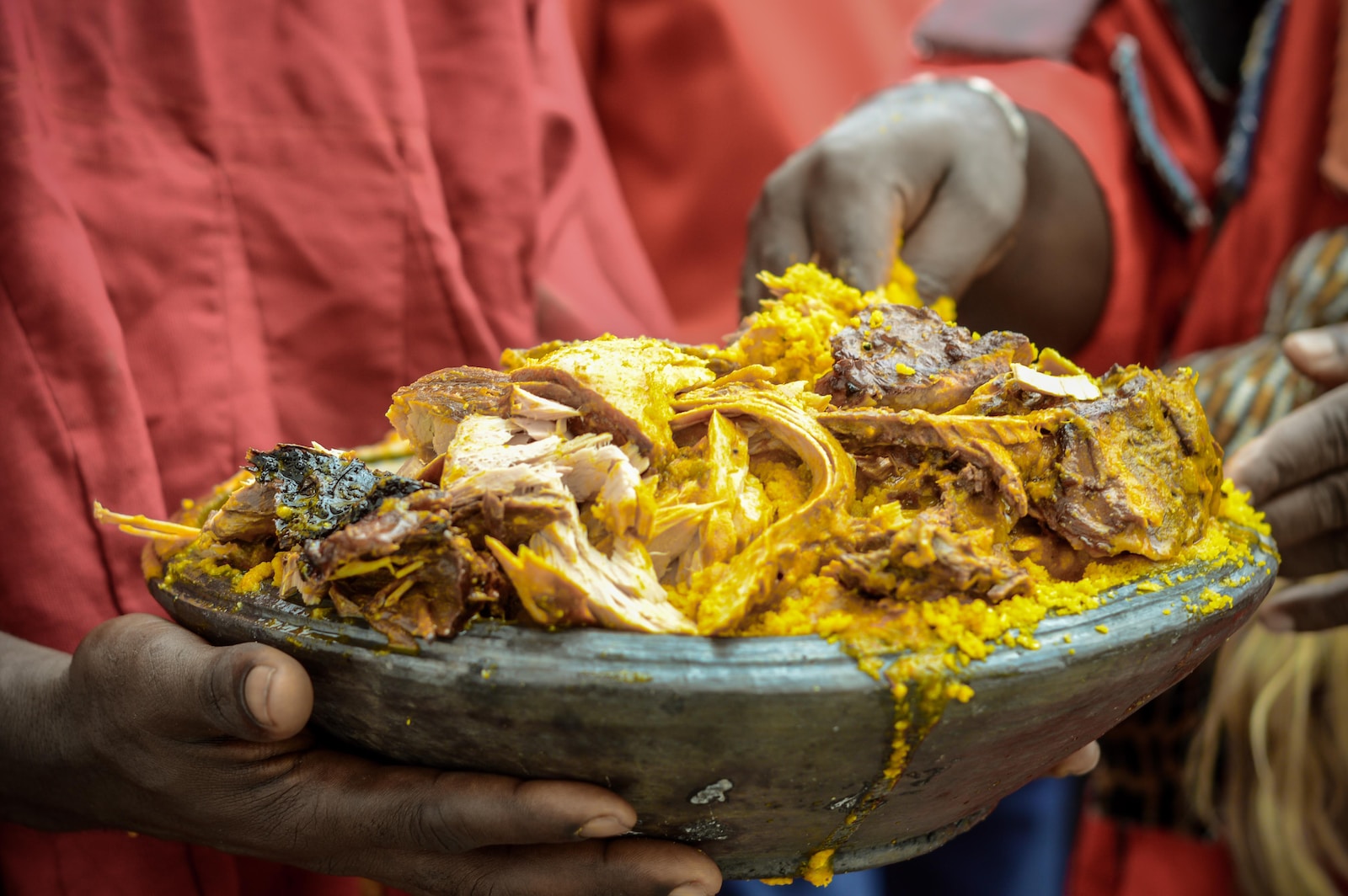 person holding a brown and yellow dish