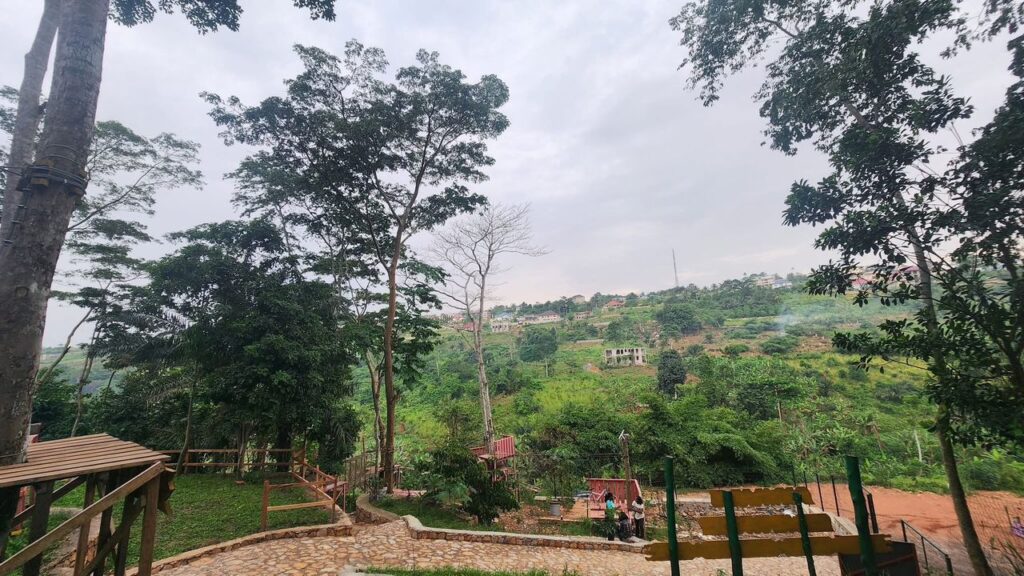 Aerial view of We-Ape Adventure Park nestled in the lush rainforest of Aburi, showcasing zipline platforms and forest trails