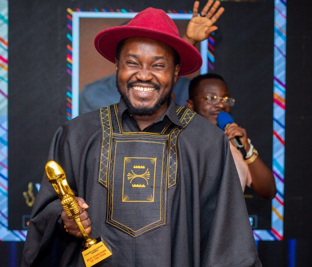 OB Amponsah holding Stand-up Comedian of the Year award at Ghana Comedy Awards 2025