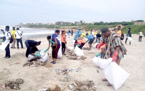 Volunteers and UN officials participating in a beach clean-up at Nungua, Ghana, to promote ocean conservation.