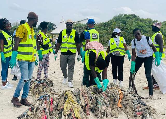 Volunteers and UN officials participating in a beach clean-up at Nungua, Ghana, to promote ocean conservation.