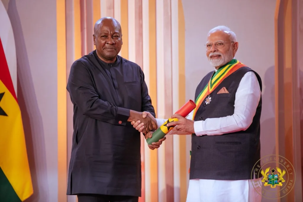 Prime Minister Narendra Modi receiving the Order of the Star of Ghana from President John Mahama at Jubilee House in Accra.